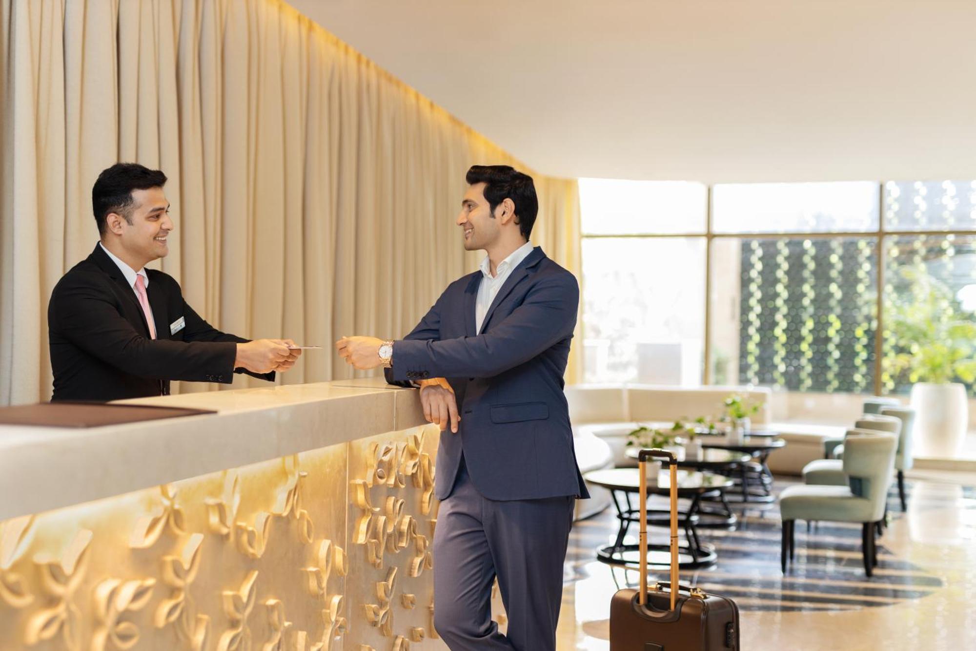 Radisson Blu Hotel New Delhi Dwarka Zewnętrze zdjęcie A guest checking in at a hotel
